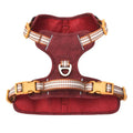 Brown leather dog harness with reflective strips and metal D-ring for lead attachment