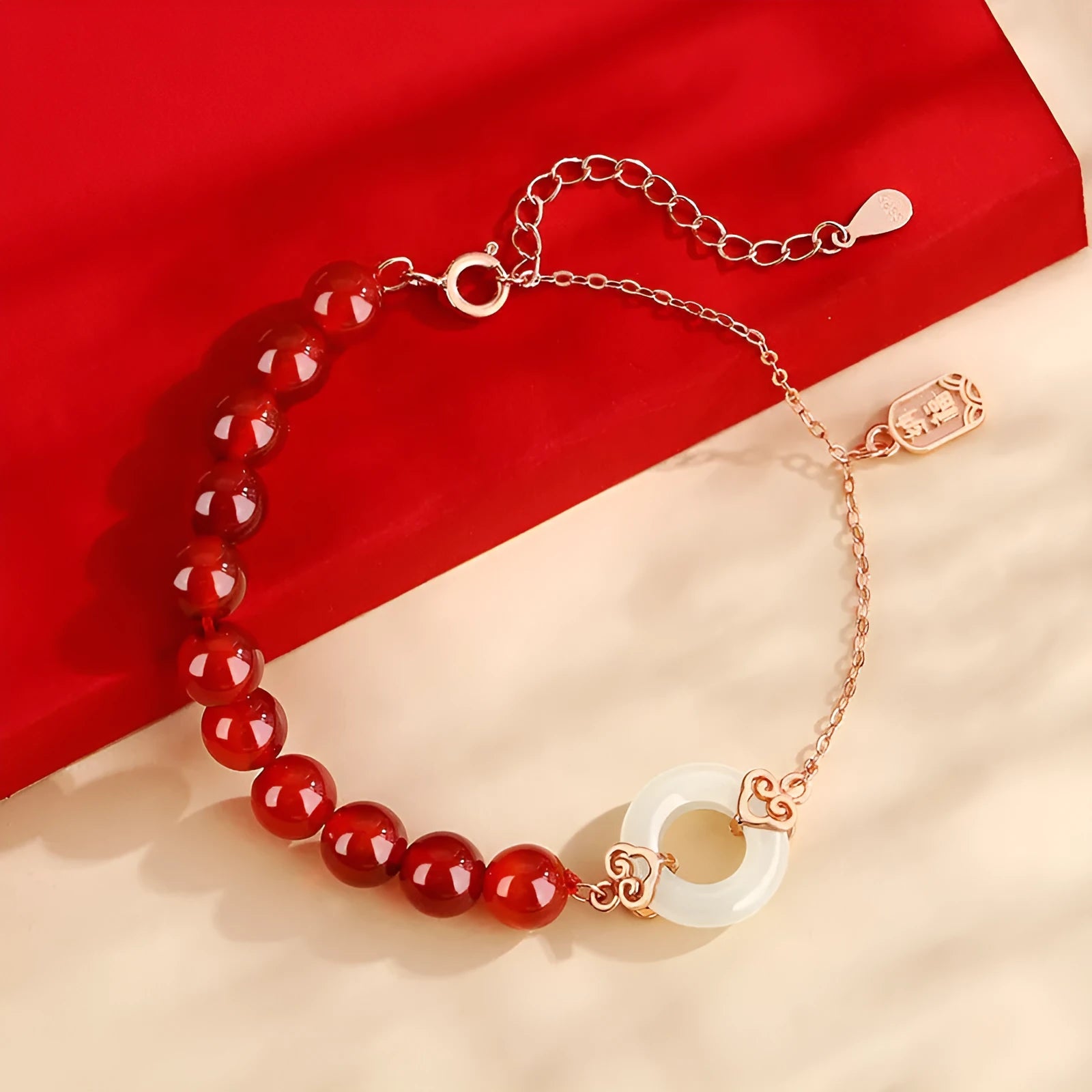 Close-up of a women's sterling silver bracelet with a peace buckle, xiangyun cloud patterns, and a Fu character.