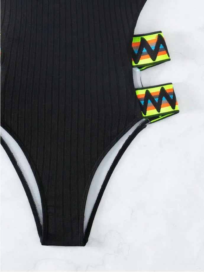 Women's solid black or orange one-piece polyester swimsuit bikini on a white background.