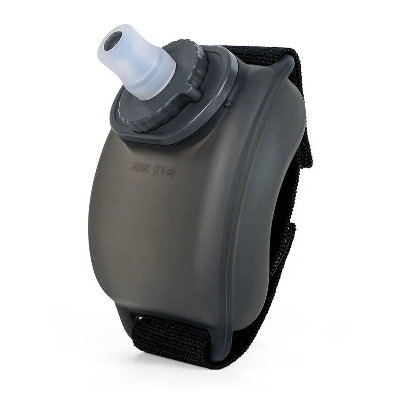 Orange wrist-mounted sports water bottle with Velcro strap showing bite-to-suck silicone mouth