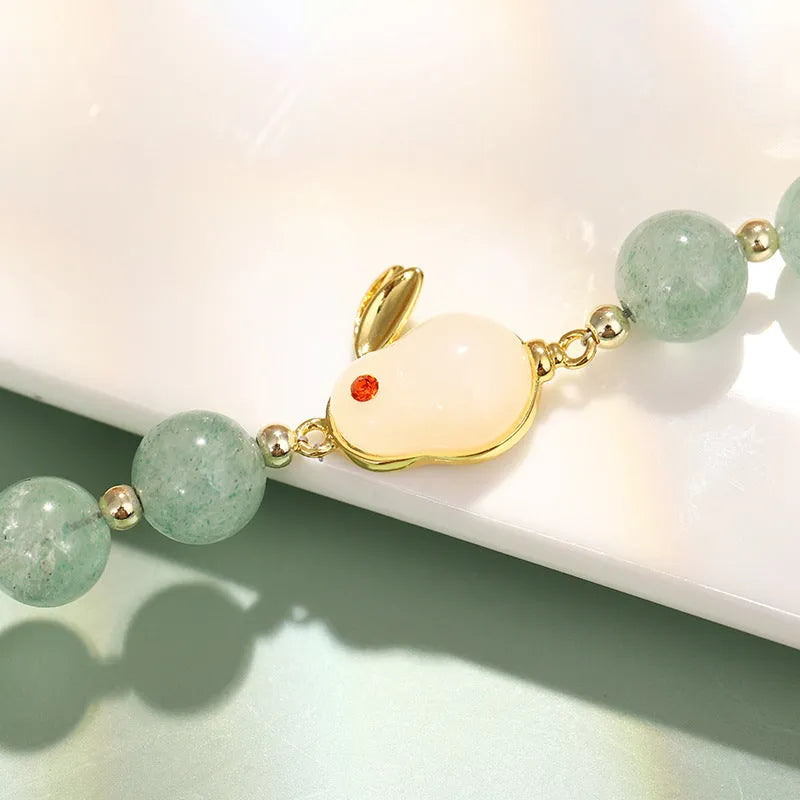 Women's rabbit design bracelet with green natural stones and copper gold accents
