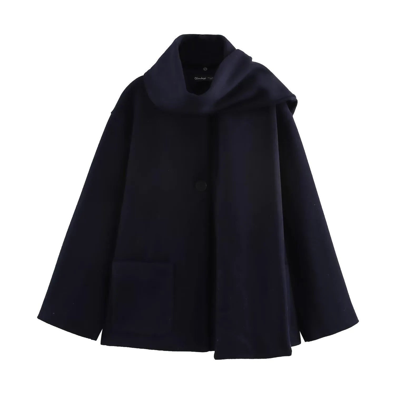 Women's long black overcoat with a grey fur collar and pockets, shown on a model.