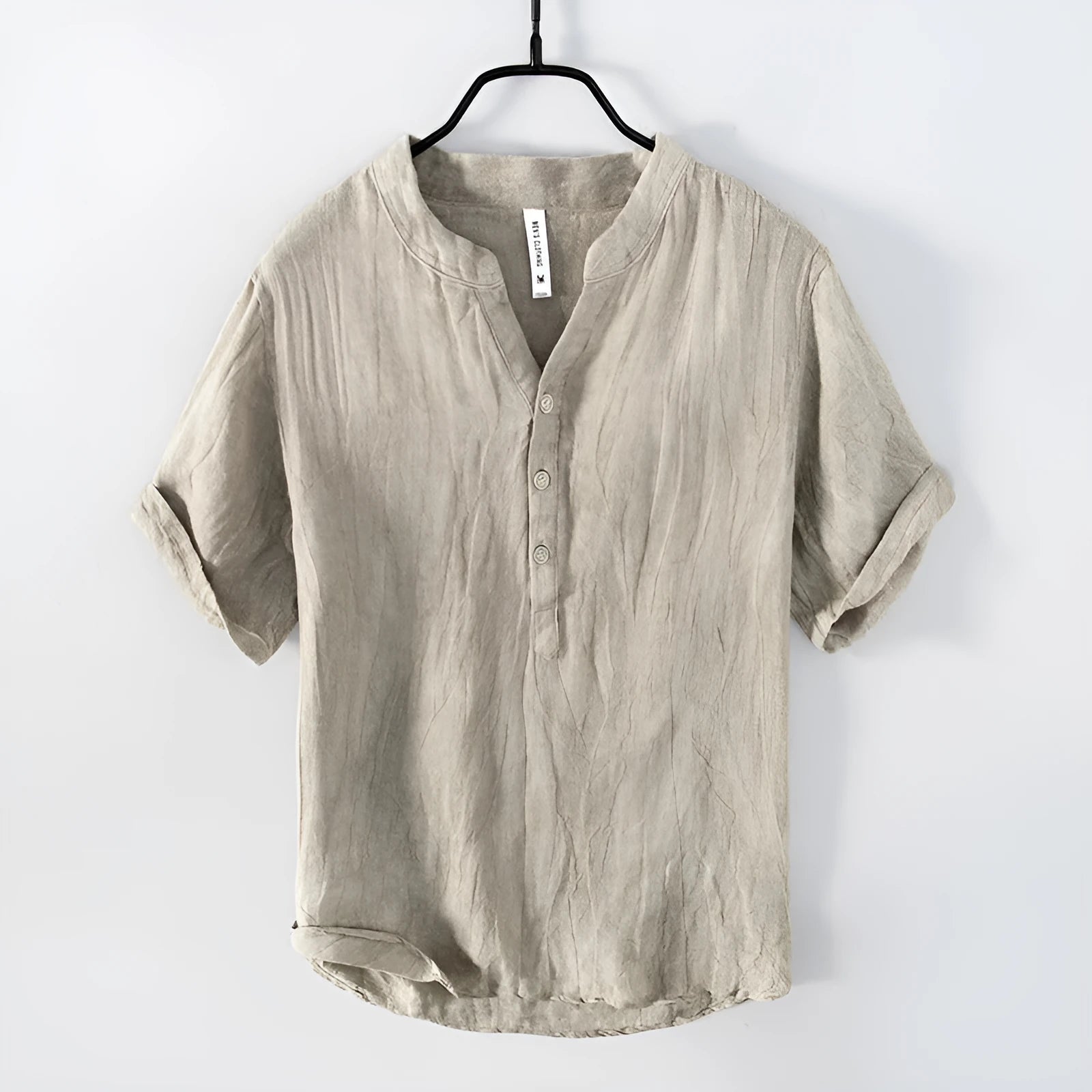 A grey linen short sleeve pullover top with a stripe pattern, laid flat.