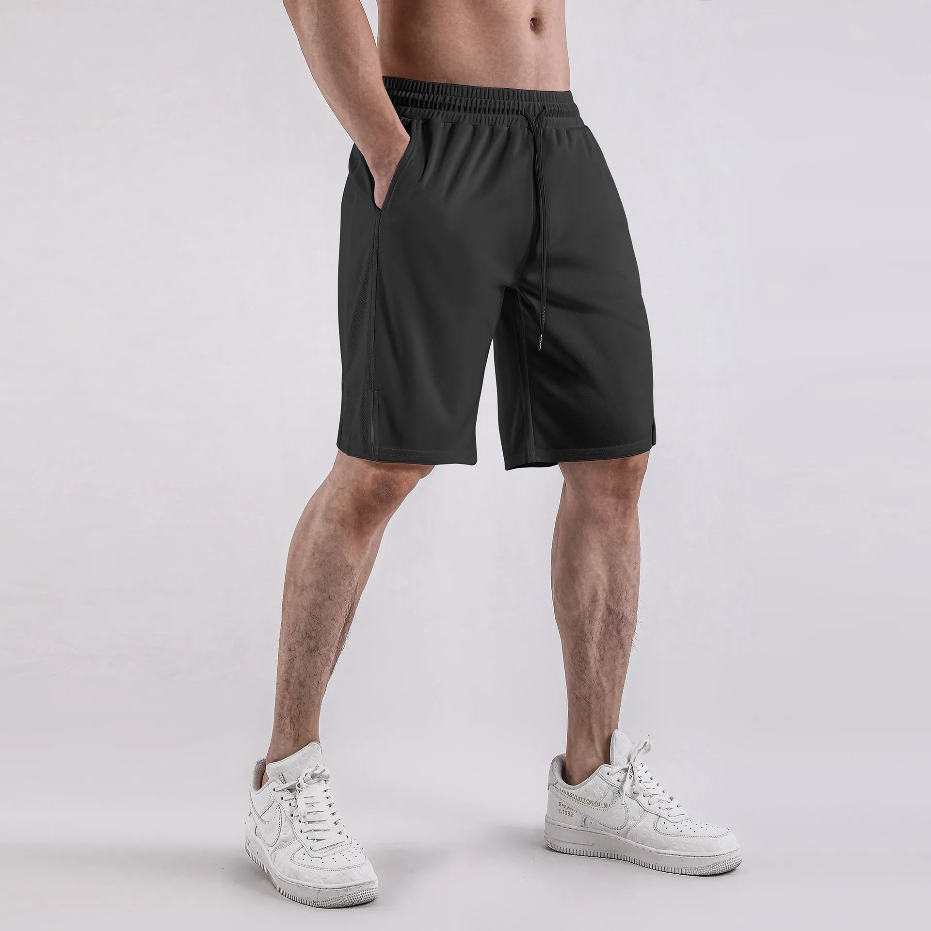 Men's black quick-dry mesh sports shorts with an elastic waistband on a white background.