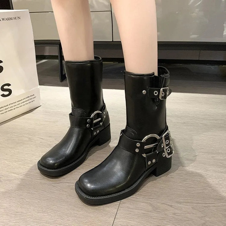 Women's black platform ankle boots with belt buckle detail and mid-calf length