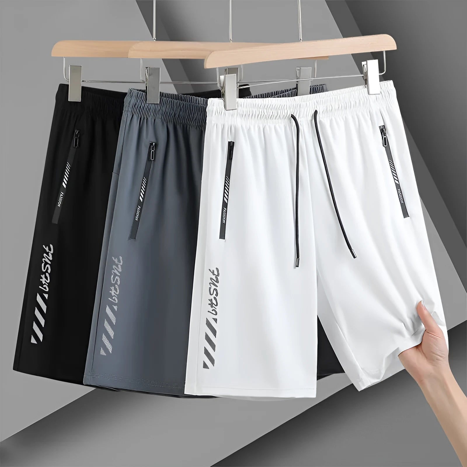 Man wearing black loose-fit quick-drying nylon sports shorts with an elastic waistband.