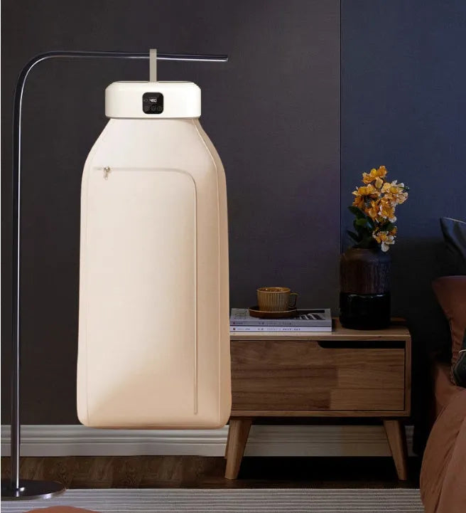White cylindrical portable clothes dryer with remote control folded for storage