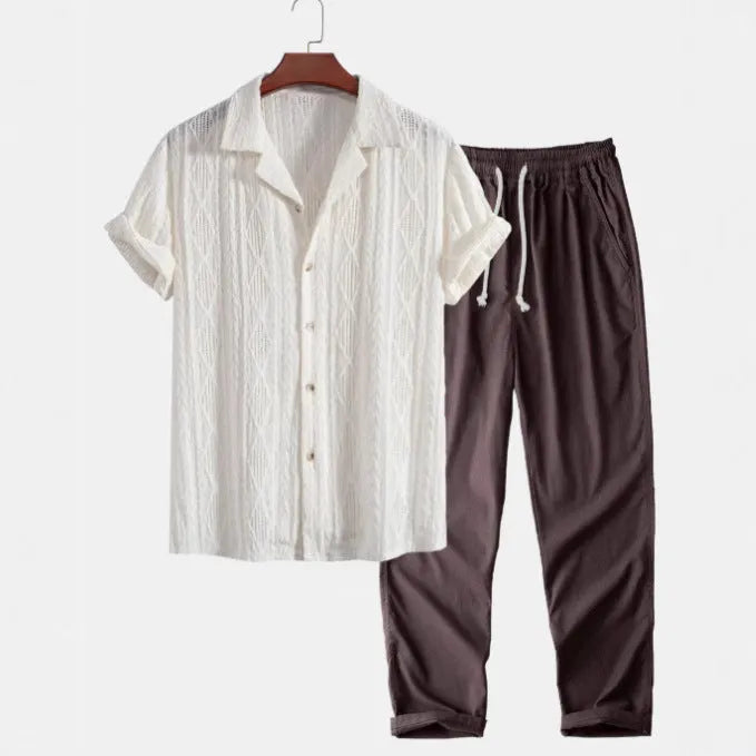 Casual linen suit set with camouflage print, featuring a short-sleeved top and matching trousers.