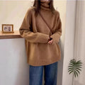 Women's loose grey turtleneck sweater with thick textured pile collar, casual style.