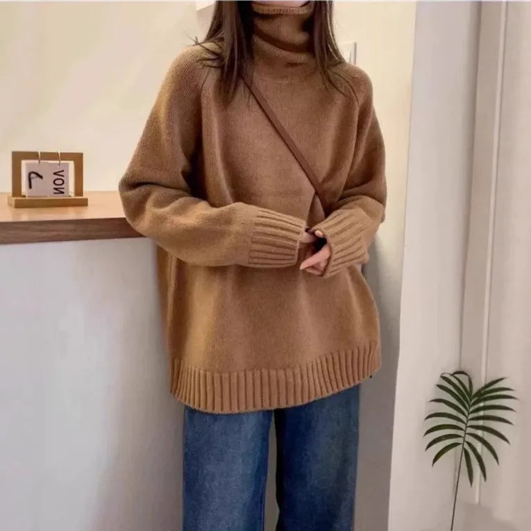 Women's loose grey turtleneck sweater with thick textured pile collar, casual style.
