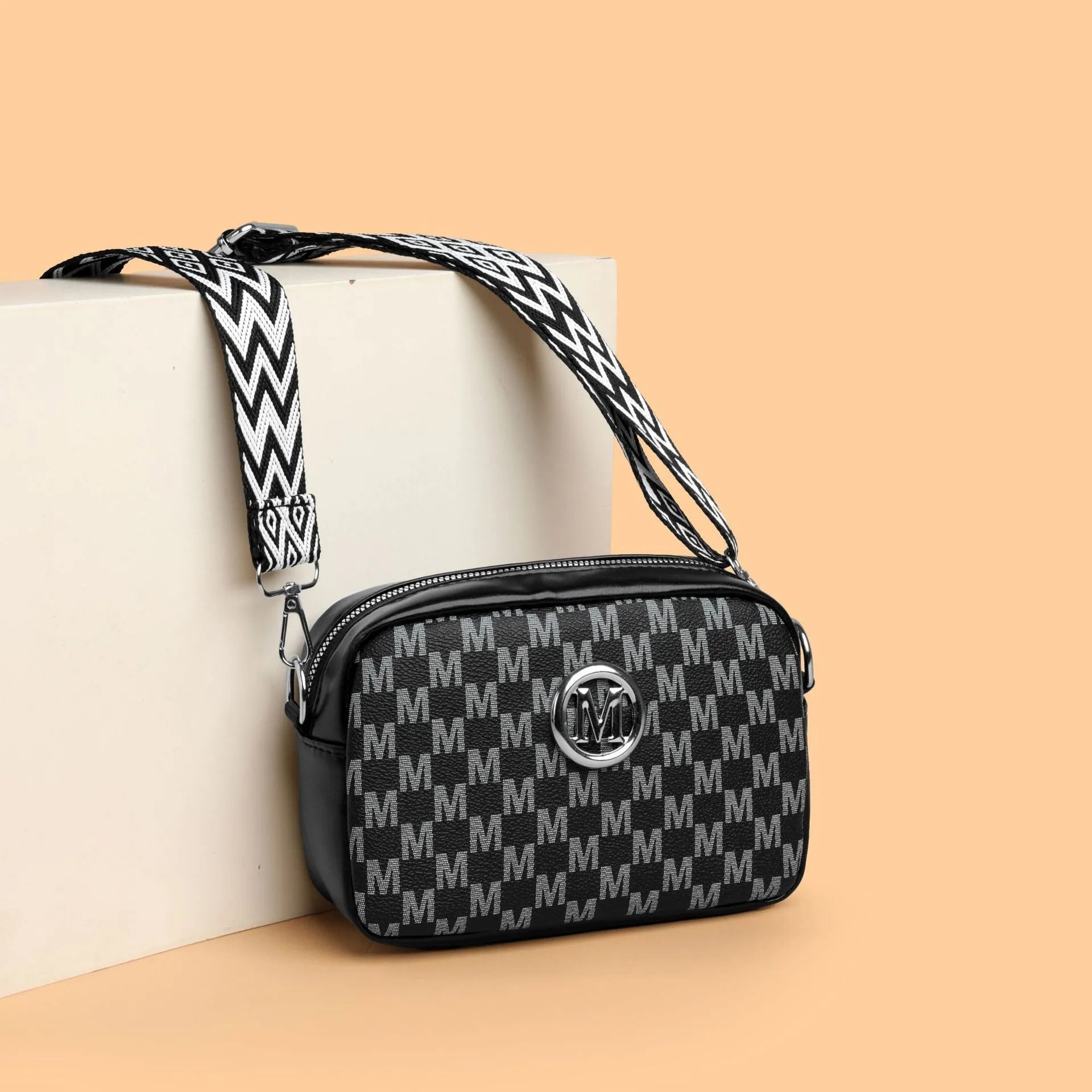 PU leather crossbody bag with wide adjustable strap and three-dimensional pocket in black colour
