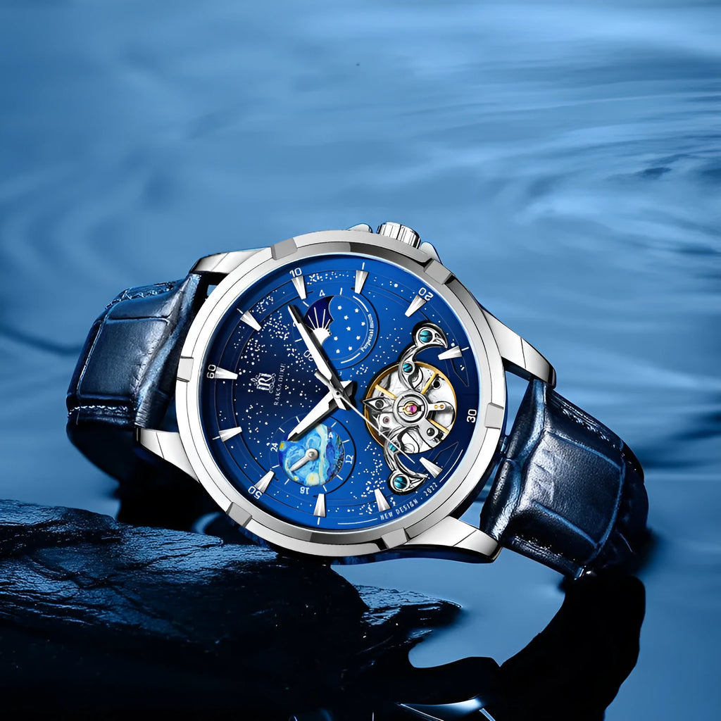Men's blue dial automatic mechanical watch with a stainless steel bracelet on wrist.