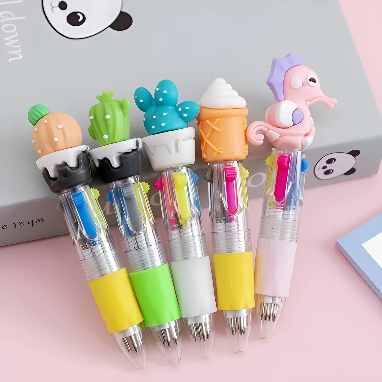 Cartoon press colour ballpoint pen with silicone grip showing four-colour mechanism and 0.7mm bullet tip