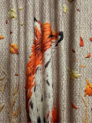 Loose-fit digital printed top with lapel collar on a hanger, shown in available sizes.