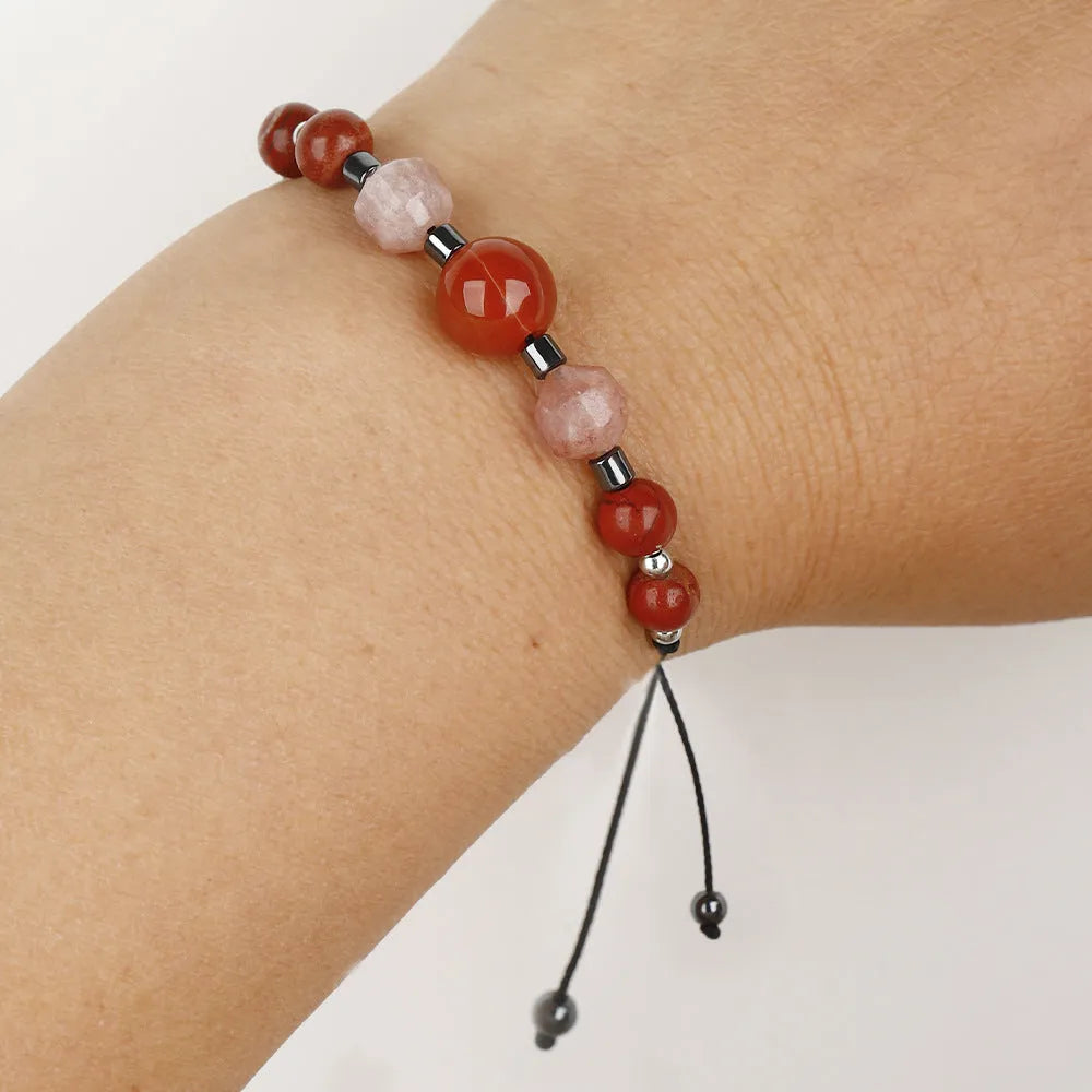 Handmade red crystal bracelet with sunstone, redstone and copper beads in a geometric design.