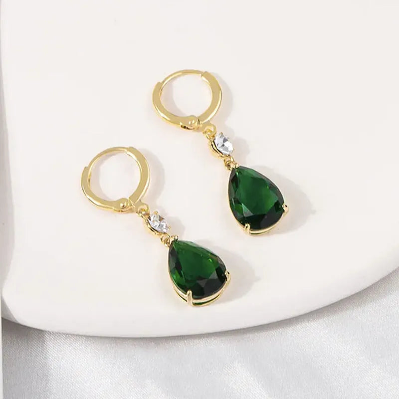 Green geometric teardrop alloy earrings on a white background