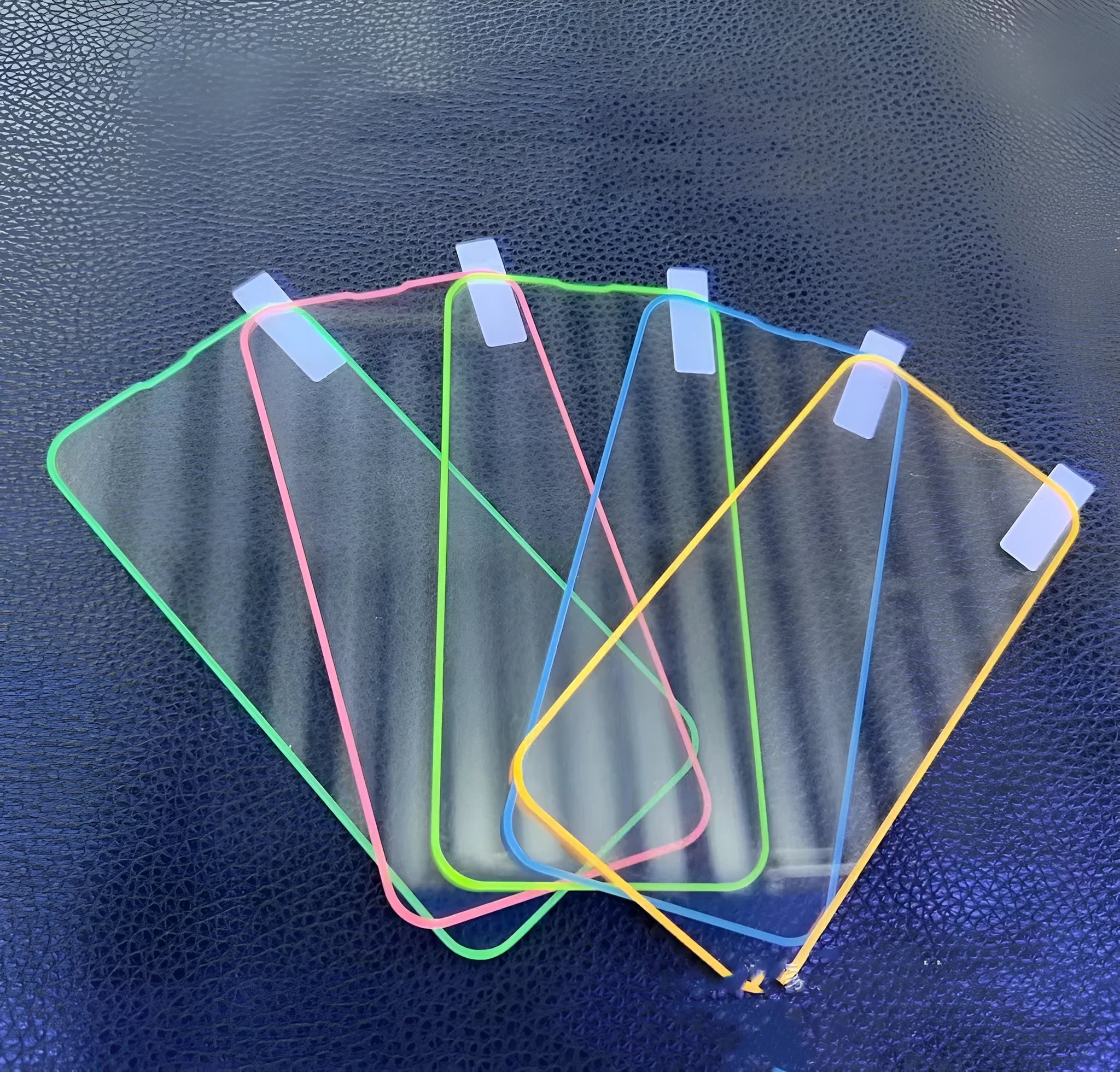 Fluorescent tempered glass screen protector for iPhone in blue luminous colour showing full front coverage.