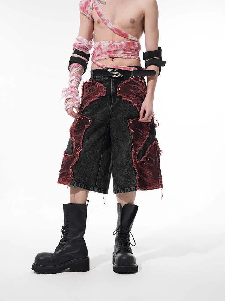 Distressed denim cropped pants with wide leg silhouette and brushed stitching details