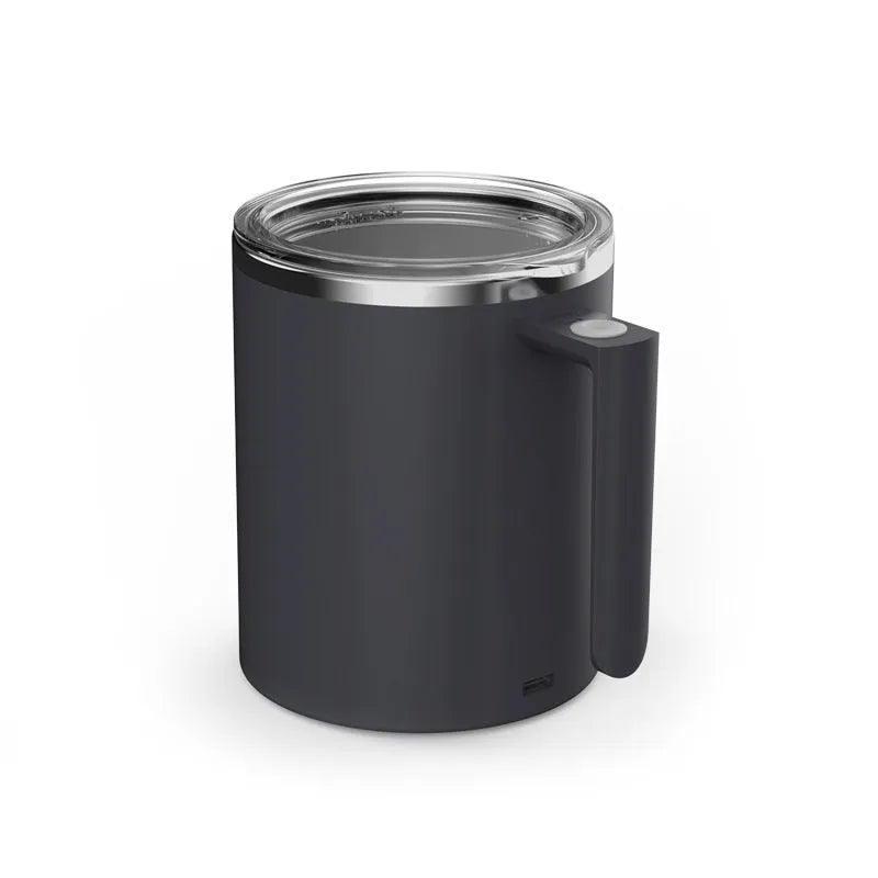 White automatic stirring coffee cup with rechargeable base on a table.