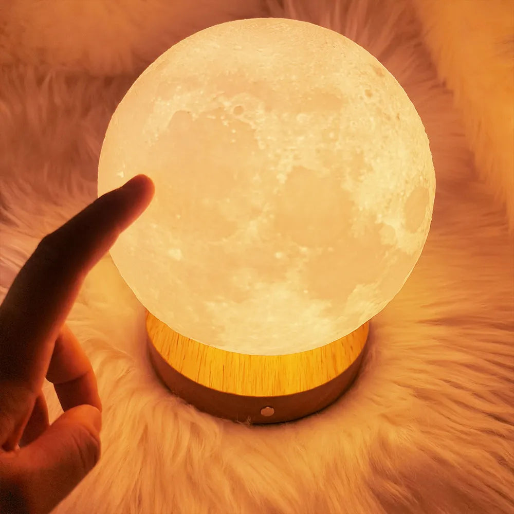 Rotating moon night lamp with wooden base showing three colour lighting options