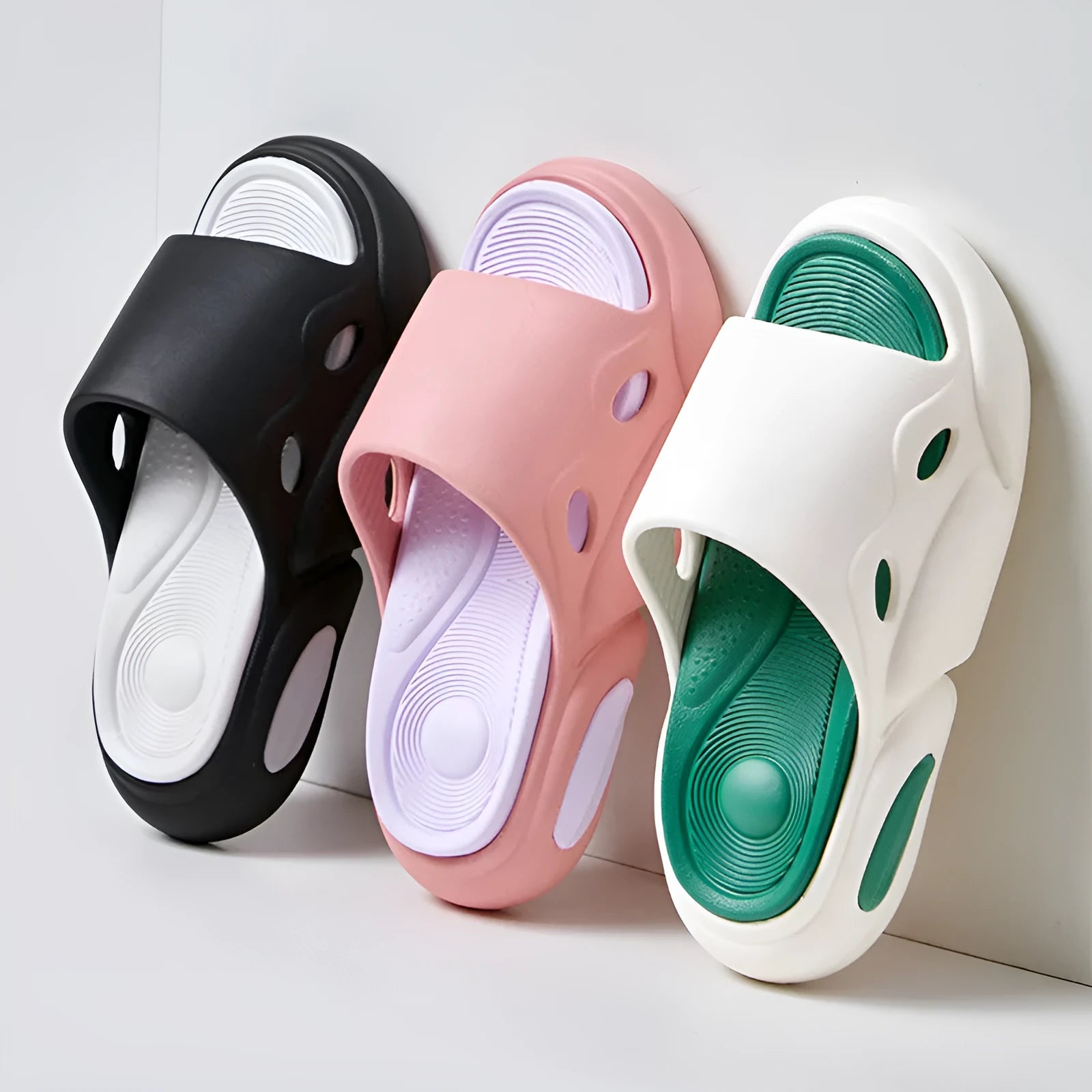 Two-colour EVA slippers showing black and white design with thick sole and leather lining