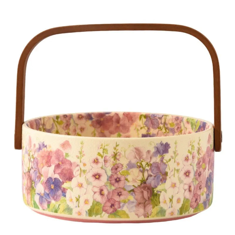 Pink ceramic fruit basket with floral pattern, 6 inches, on tea table with fruit
