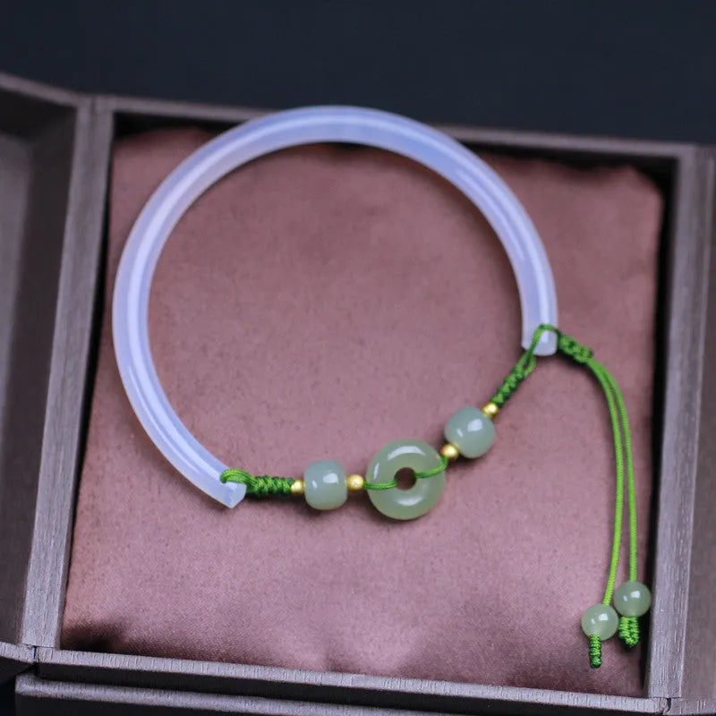 Hand-woven white agate bracelet with hetian jade accents and traditional peace buckle on wrist
