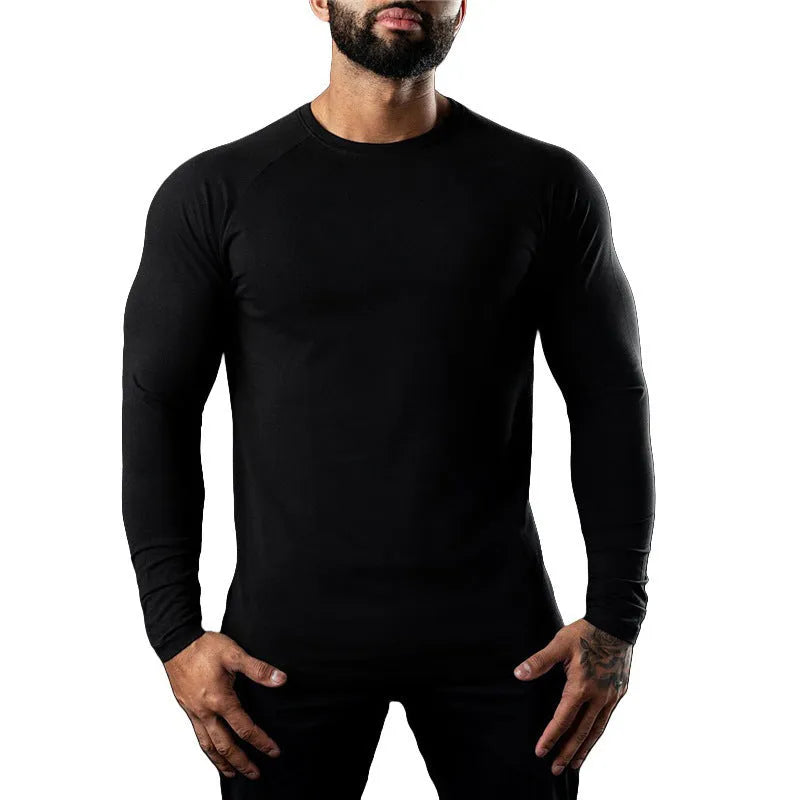 Man wearing a grey long sleeve cotton sports t-shirt with a round neck.