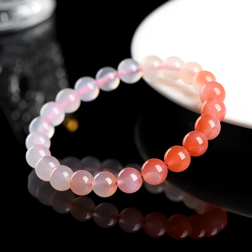 Natural gradient Yanyuan agate bracelet with geometric beads on a wrist, showing salt source colour variation.