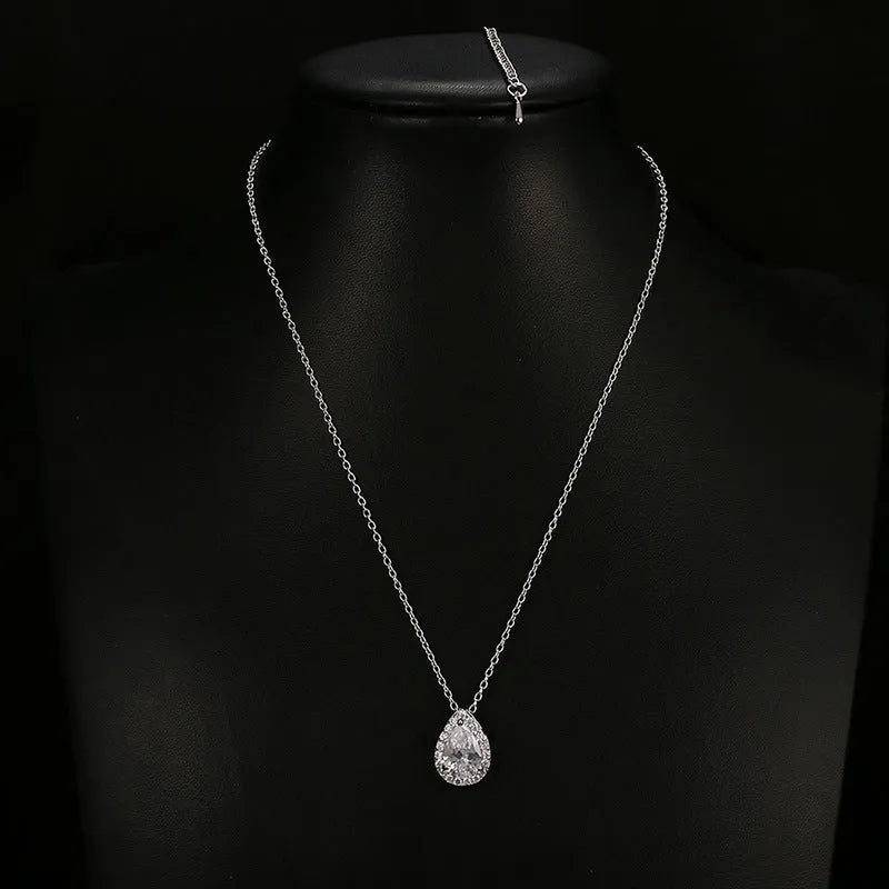 Women's water drop gemstone necklace and earrings set in copper with zircon on white background