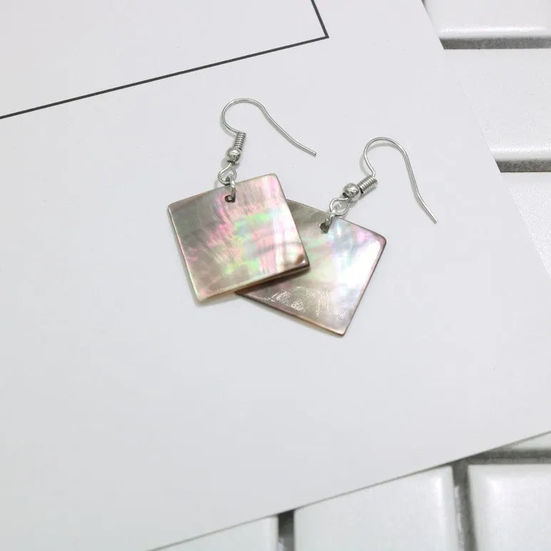 Women's geometric shell earrings showing rectangular and square shapes with natural shell material texture