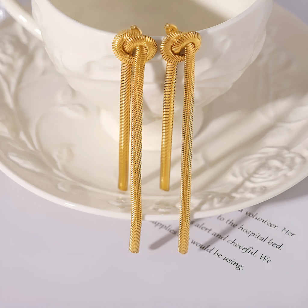Gold electroplated titanium steel necklace with knotted tassel pendant on snake chain and matching earrings