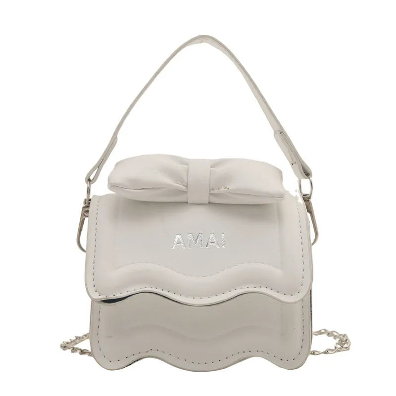 Mini crossbody bag in PU leather with adjustable strap shown in seven colour options