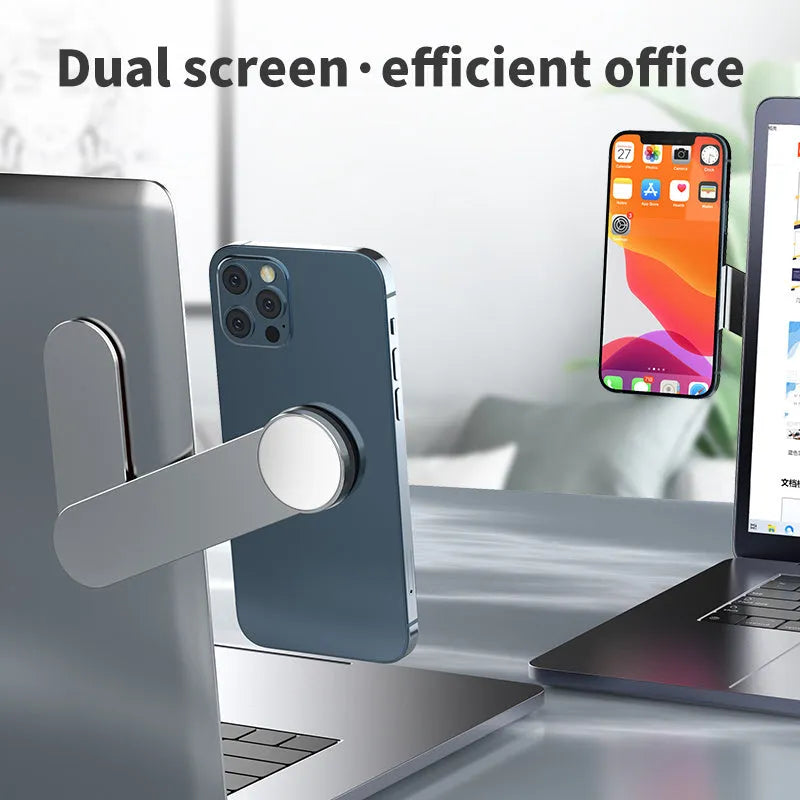 Silver aluminium alloy mobile phone bracket with magnetic attachment mounted next to computer screen