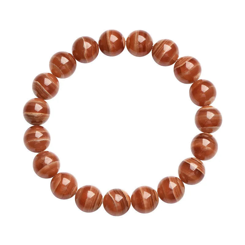 Natural old mine rhodochrosite round bead bracelet with geometric and Ruyi design on a wrist.