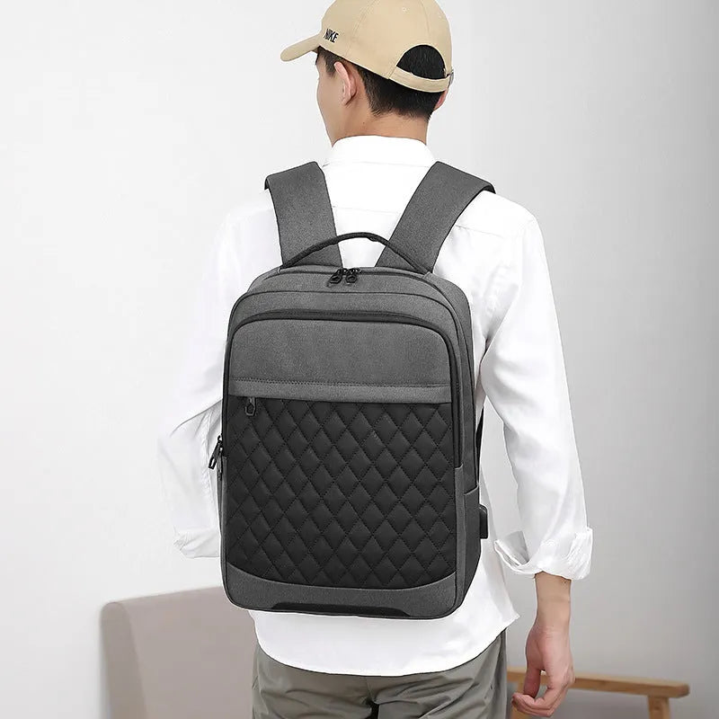 Men's solid colour Oxford cloth travel backpack with curved straps and diamond mesh detail, shown in grey.