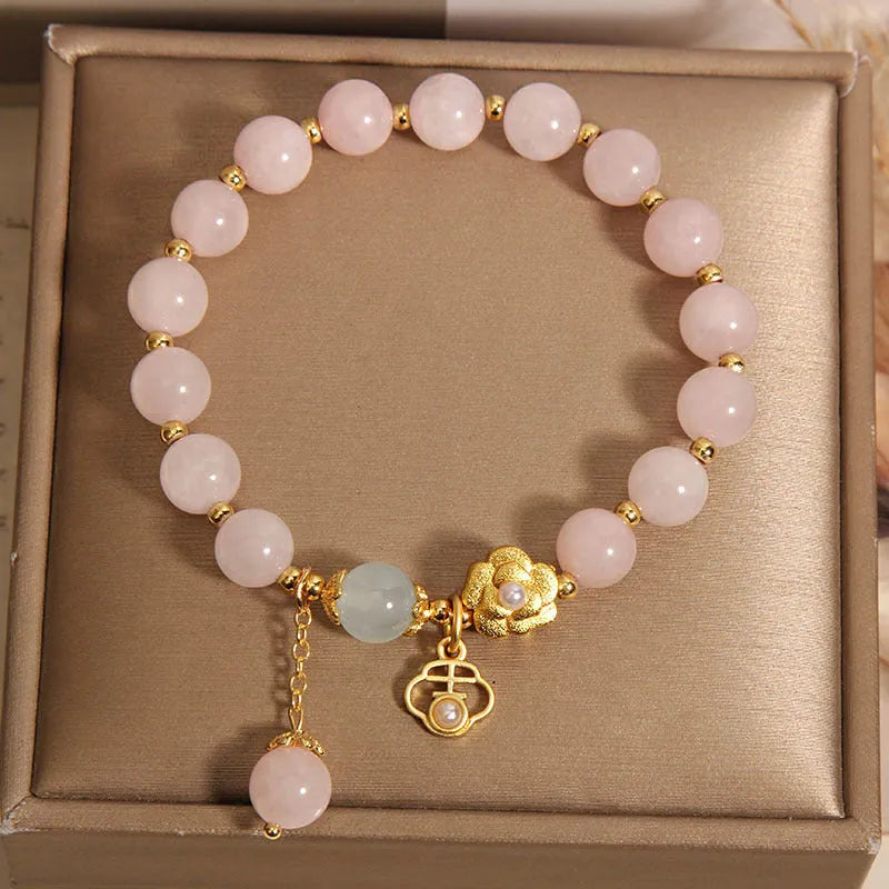 Women's pink crystal flower bracelet with clear crystal stones forming floral design pattern.