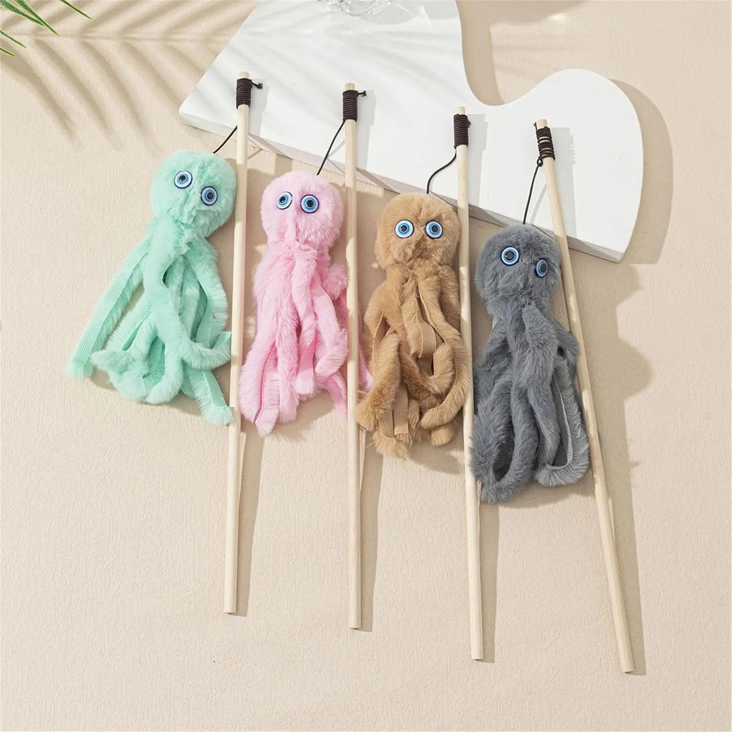 Octopus design cat toy with movable eyes on a long stick, shown in grey, pink, purple, or red.