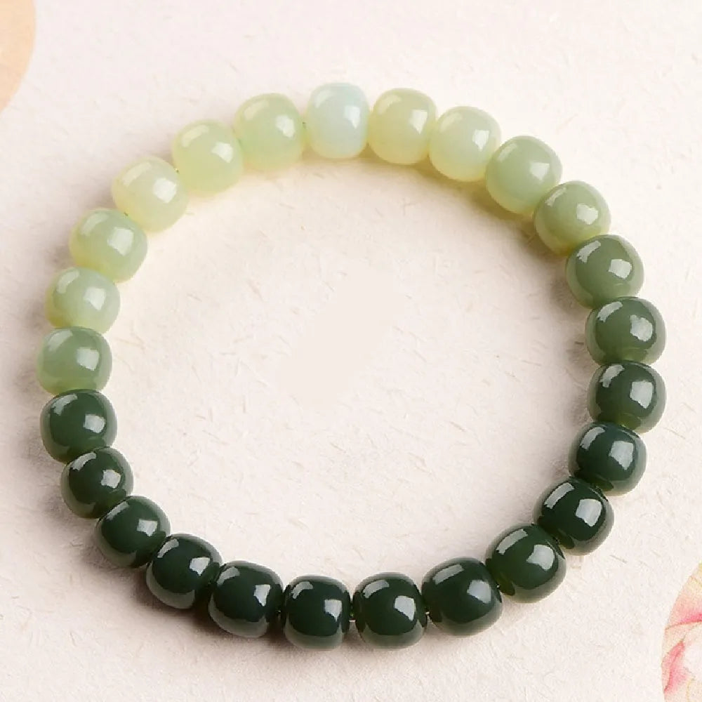 Polished Hetian jade bracelet with clear water gradient colour on wrist.