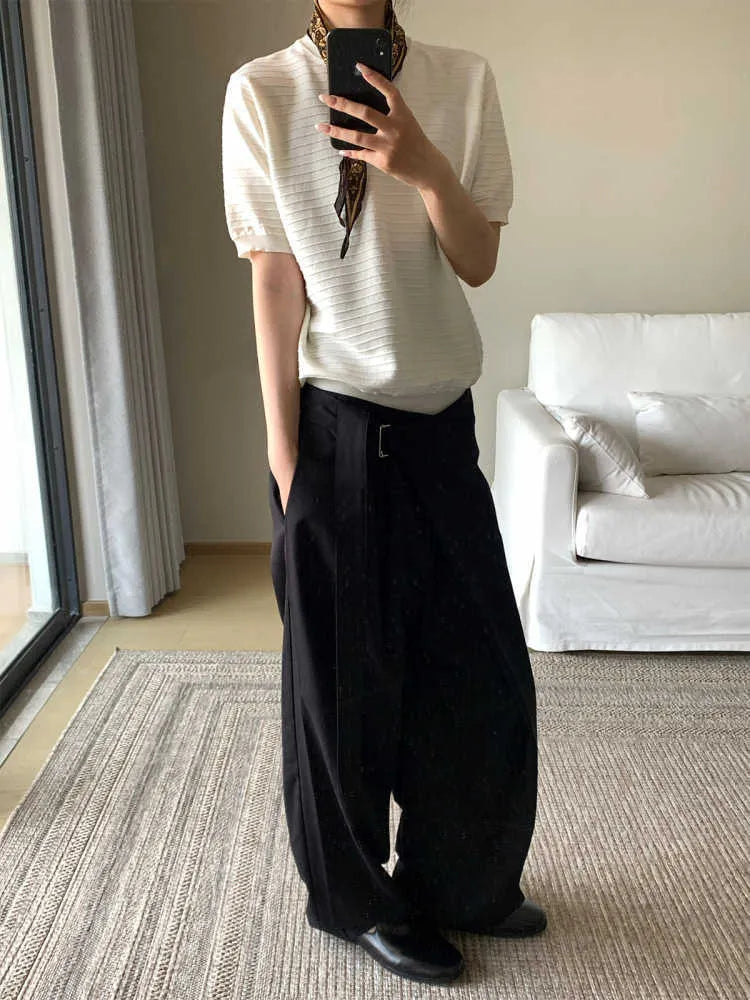 Black straight leg trousers with a single front pleat and an adjustable waistband on a hanger.