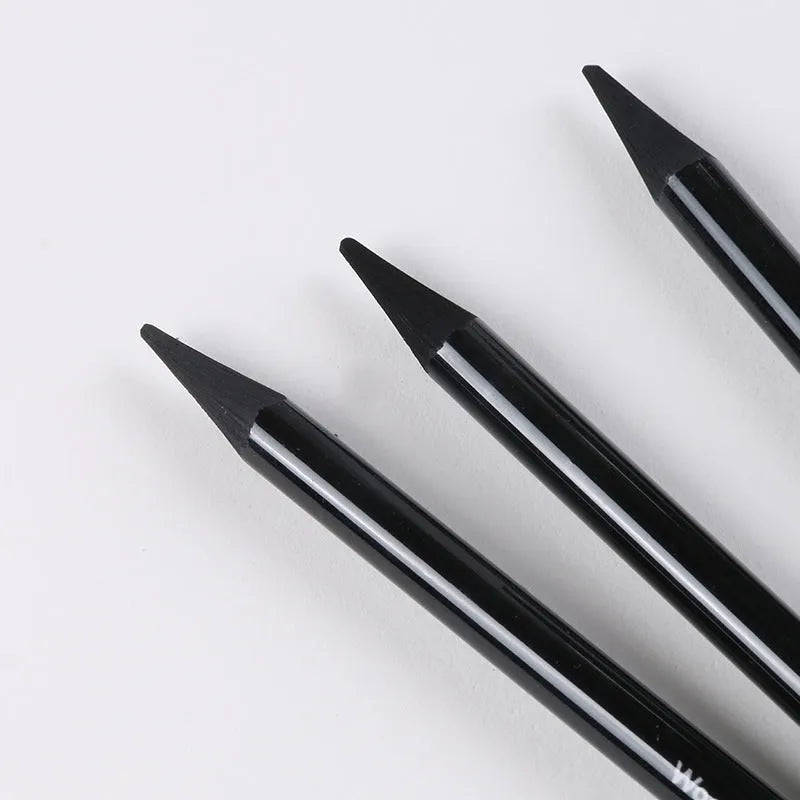 Set of nine graphite and carbonised drawing pencils in wooden casings on a suction card.