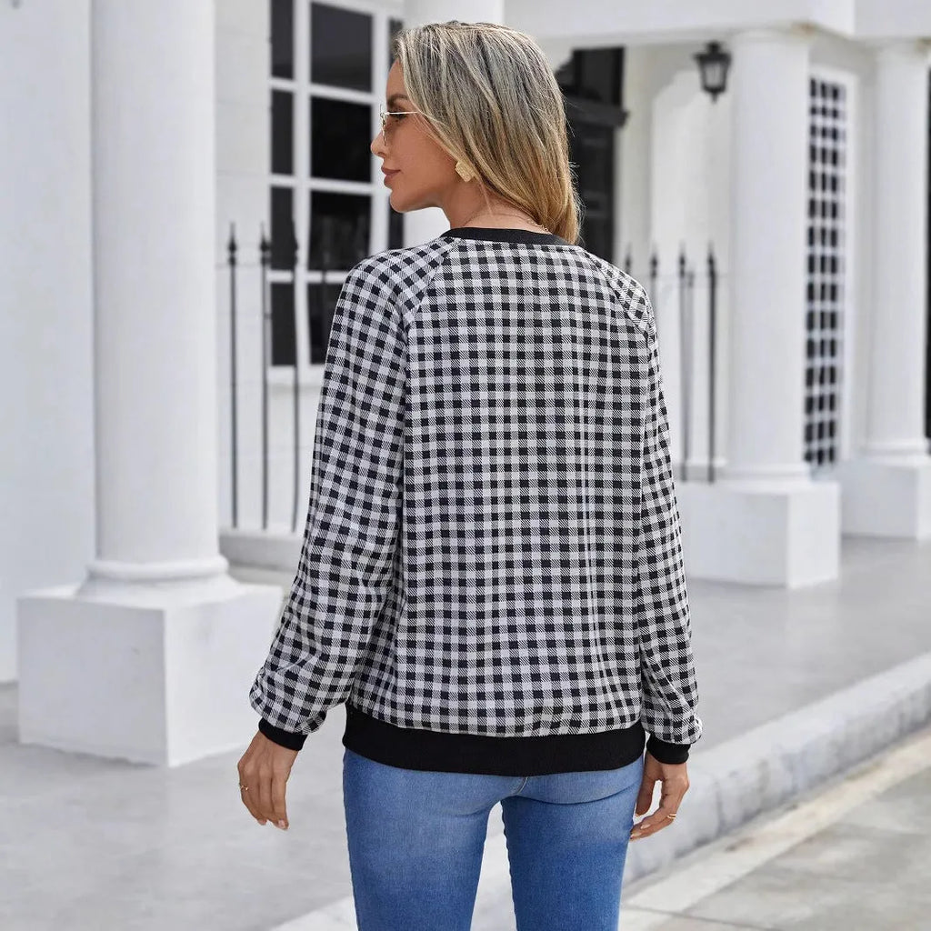 Black long sleeve polyester sweater with a plaid pattern, shown on a hanger.