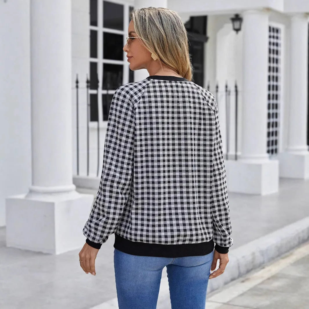 Black long sleeve polyester sweater with a plaid pattern, shown on a hanger.