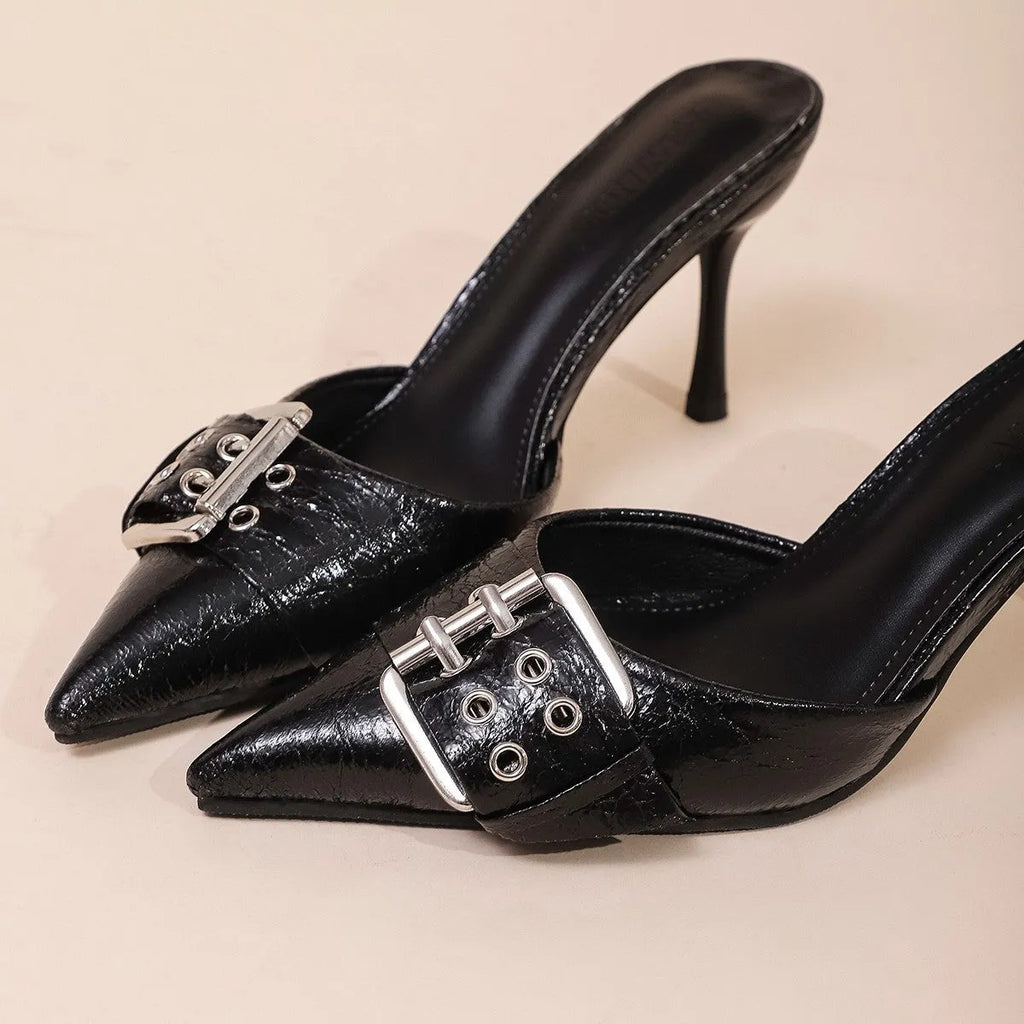 Black women's high heels with decorative buckle on ankle strap and pointed toe design