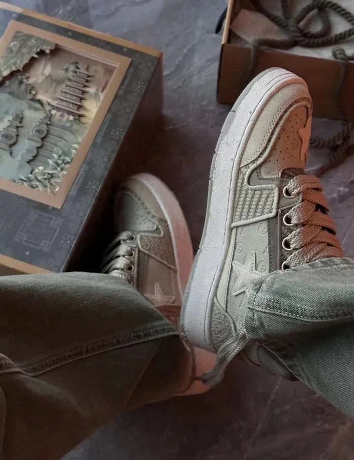 Green low-top casual shoes with star pattern stitching and thick rubber sole.