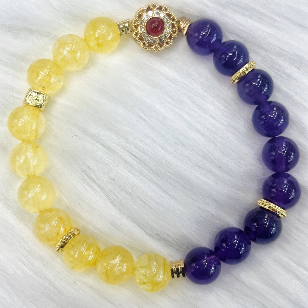 Handmade women's bracelet with yellow and purple amethyst crystals on wrist