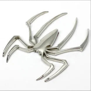 Three-dimensional metal spider bumper sticker in metallic finish measuring 7cm by 5cm