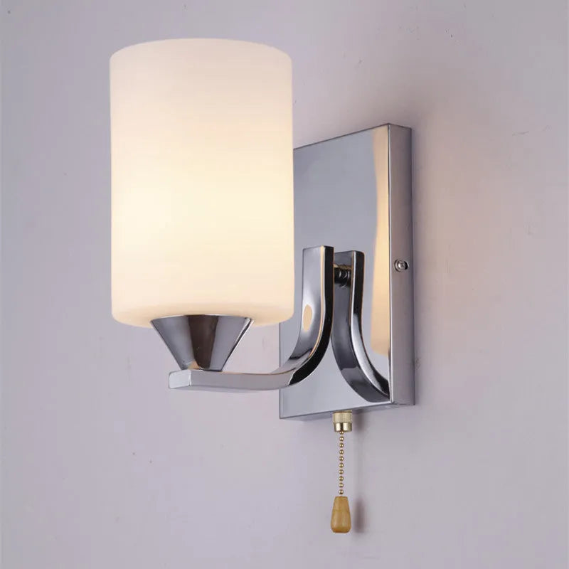 Modern chrome-finished wall lamp with a glass shade, shown in single-head and double-head configurations.