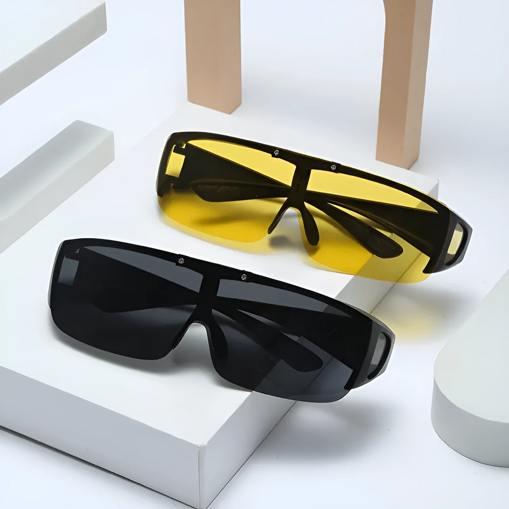 One-piece polarised sunglasses with myopia correction and multiple interchangeable coloured lens sheets laid out.