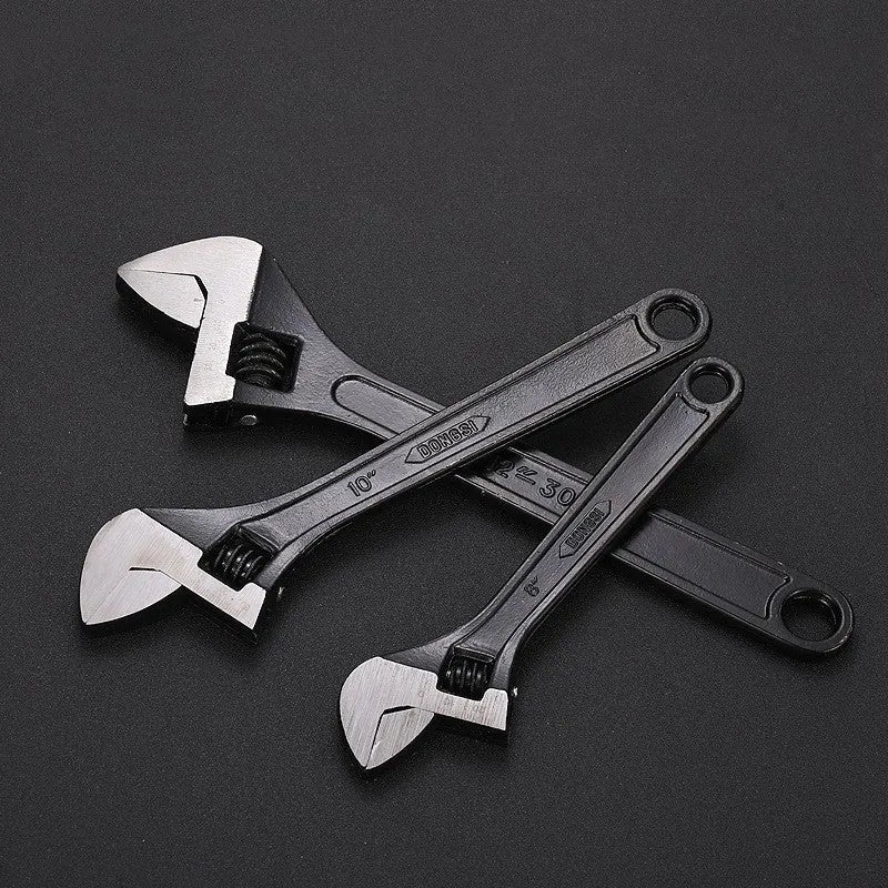 10-inch black high carbon steel adjustable open-end wrench on a workbench